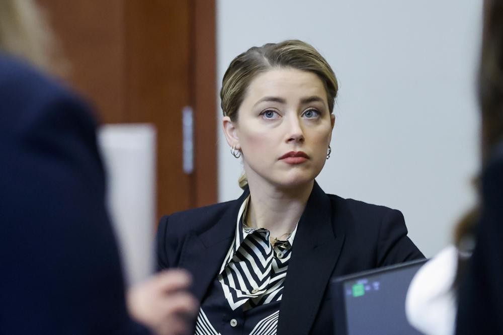 Actor Amber Heard appears in the courtroom at the Fairfax County Circuit Court in Fairfax, Va., Wednesday, April 27, 2022. Actor Johnny Depp sued his ex-wife actress Amber Heard for libel in Fairfax County Circuit Court after she wrote an op-ed piece in The Washington Post in 2018 referring to herself as a "public figure representing domestic abuse." (Jonathan Ernst/Pool Photo via AP)